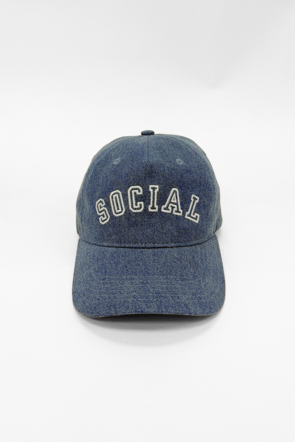 Blue denim cap with 'SOCIAL' embroidery on a white background